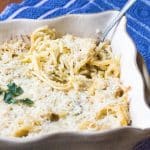 Cauliflower tetrazzini pasta casserole in a baking dish, topped with parsley.