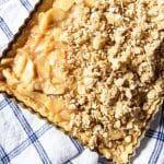 Apple pie crumb bars with filling and some crumble over the top.