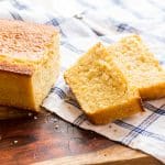 A loaf of buttermilk cornbread with 2 slices separated out.