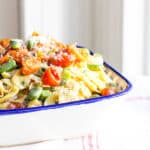 A bowl of tortellini pasta tossed with fava beans, tomatoes and herbed ricotta cheese.