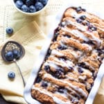 A loaf of blueberry scone bread in a loaf pan.