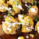 Loaded, smashed and roasted potatoes with melted cheese, green onions, sour cream and dried red peppers.