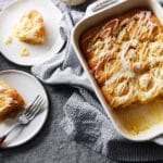 A baking dish of orange rolls with 2 rolls on 2 different plates.